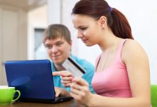 couple buying online with laptop credit card