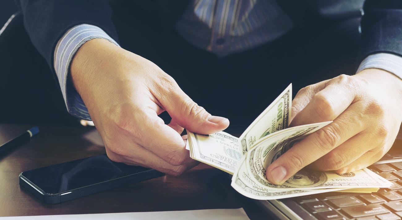 Business man counting dollar banknote - online business concept